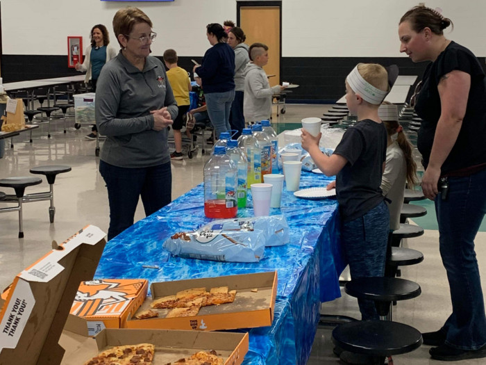 Literacy Night attendees eating pizza