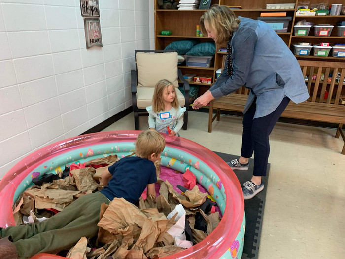 Adult helping boy and girl at Literacy Night